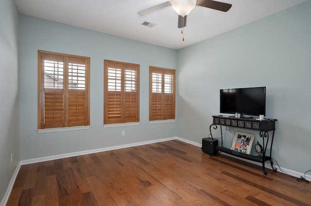 unfurnished living room featuring visible vents, ceiling fan, wood finished floors, and baseboards
