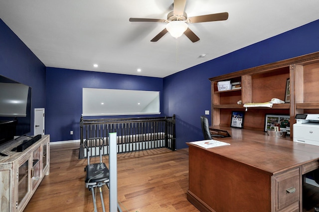 office area featuring baseboards, a ceiling fan, and wood finished floors