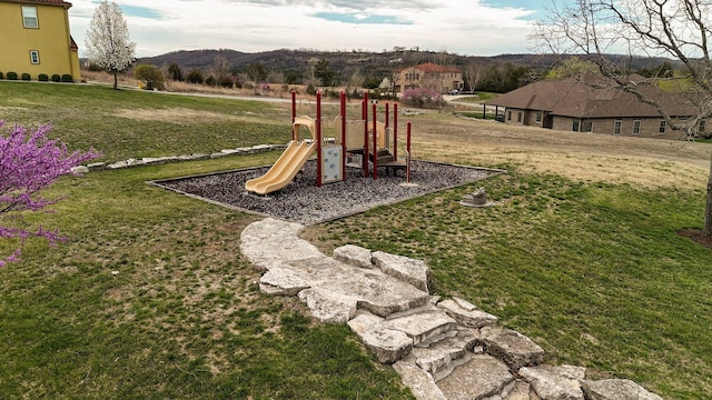 community jungle gym featuring a lawn