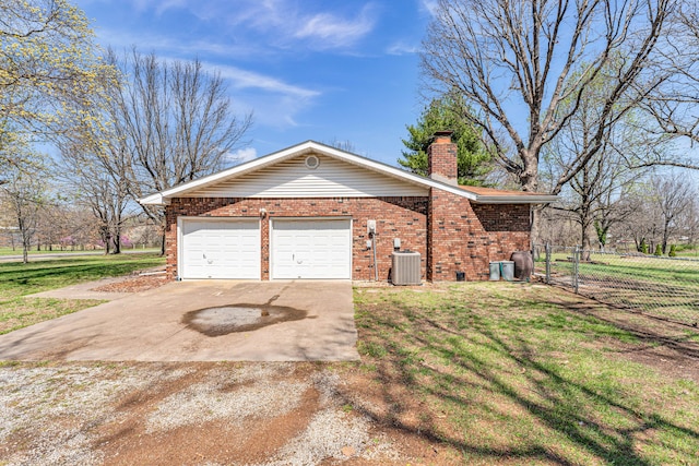 view of side of home featuring central AC, a lawn, a chimney, brick siding, and driveway