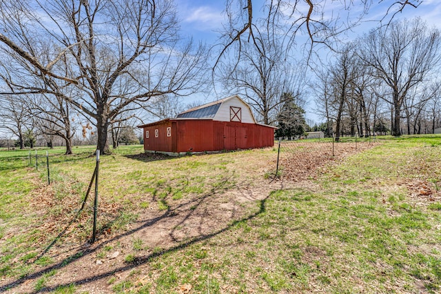 view of yard with a barn and an outbuilding