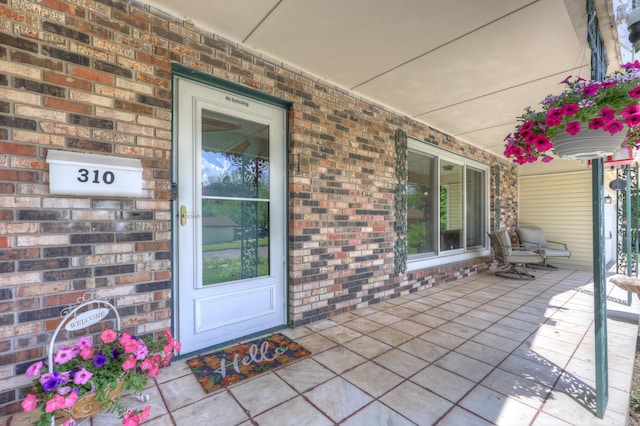 310 W Wishart Dr, Monett, MO 65708 - property entrance featuring a porch and brick siding