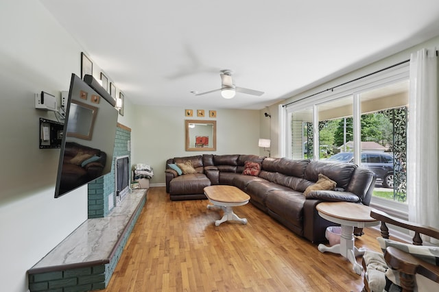 310 W Wishart Dr, Monett, MO 65708 - living area featuring ceiling fan, a fireplace, and light wood-type flooring