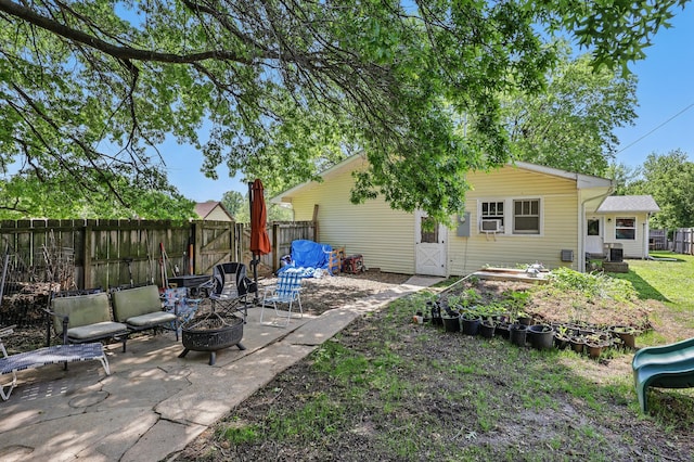 310 W Wishart Dr, Monett, MO 65708 - back of property with a fire pit, a fenced backyard, and a patio