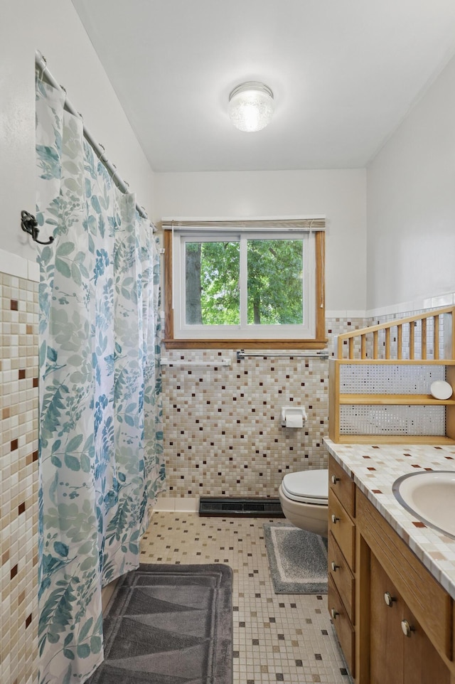 310 W Wishart Dr, Monett, MO 65708 - bathroom with toilet, tile walls, a shower with shower curtain, vanity, and wainscoting