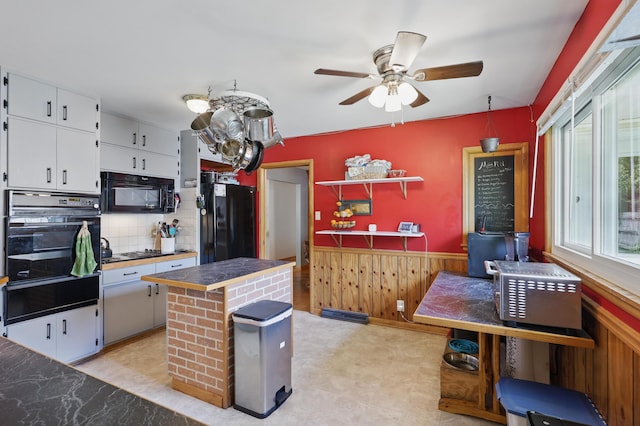 310 W Wishart Dr, Monett, MO 65708 - kitchen with black appliances, a warming drawer, white cabinets, a ceiling fan, and backsplash