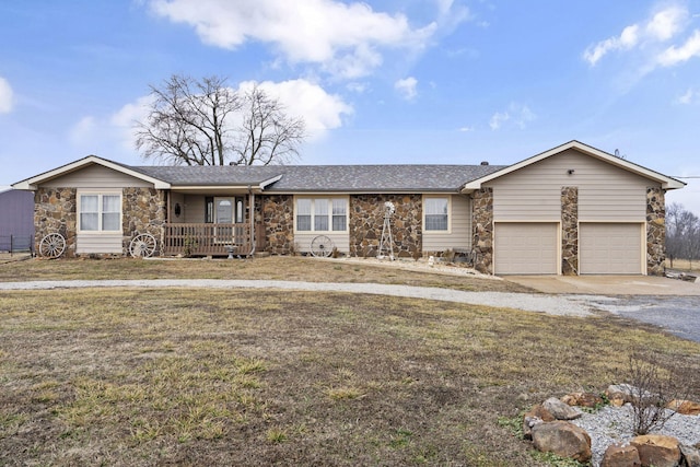 ranch-style house with an attached garage, a front lawn, stone siding, and driveway