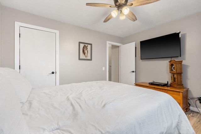 bedroom with light wood-style flooring and ceiling fan