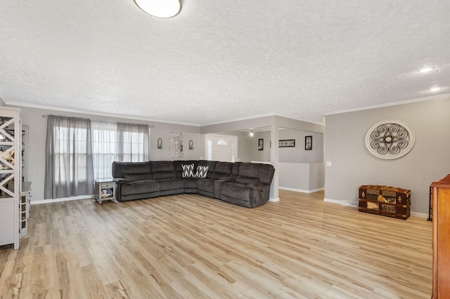 living area with light wood-style flooring, baseboards, ornamental molding, and a textured ceiling