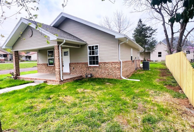 100 E Bond St, Monett, MO 65708 - exterior space with central AC unit, a yard, fence, a patio, and brick siding