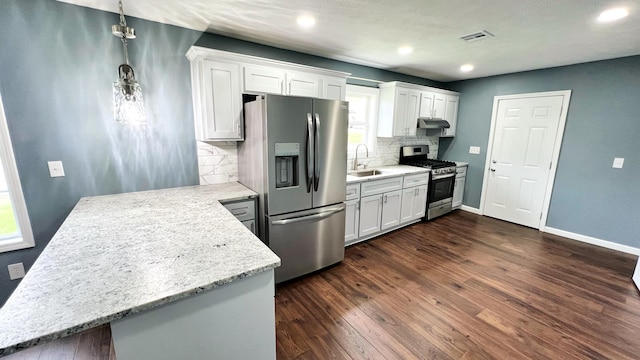 100 E Bond St, Monett, MO 65708 - kitchen featuring visible vents, baseboards, appliances with stainless steel finishes, dark wood finished floors, and under cabinet range hood