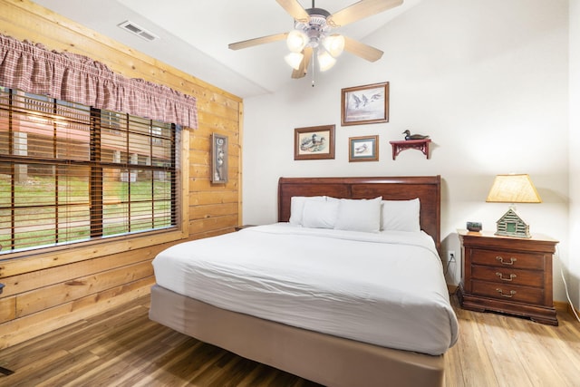 135 Rock Candy Ln, Branson, MO 65616 - bedroom featuring wooden walls, visible vents, a ceiling fan, and wood finished floors
