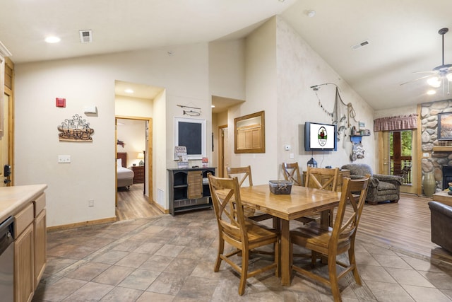 135 Rock Candy Ln, Branson, MO 65616 - dining space featuring light tile patterned flooring, high vaulted ceiling, ceiling fan, and visible vents