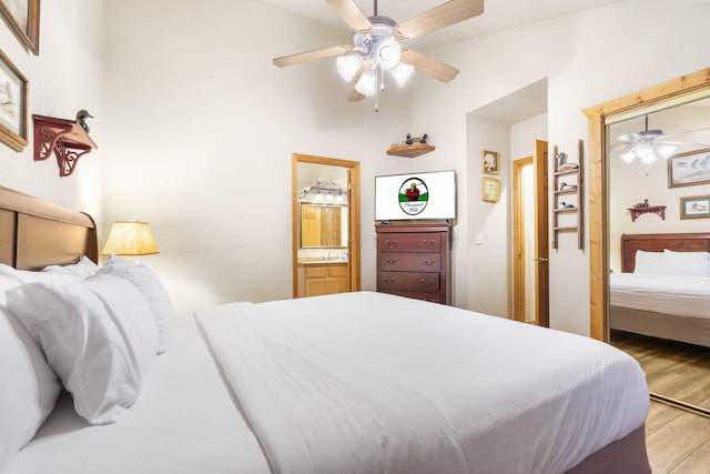 135 Rock Candy Ln, Branson, MO 65616 - bedroom featuring wood finished floors, ensuite bath, and a ceiling fan