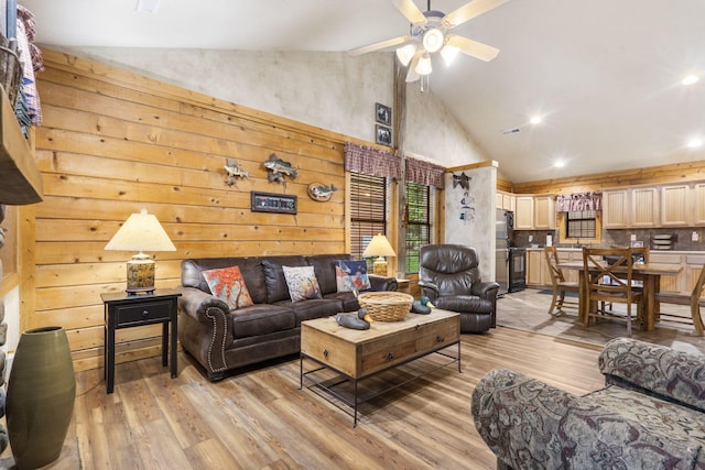 135 Rock Candy Ln, Branson, MO 65616 - living area with light wood-type flooring, recessed lighting, a ceiling fan, wood walls, and high vaulted ceiling
