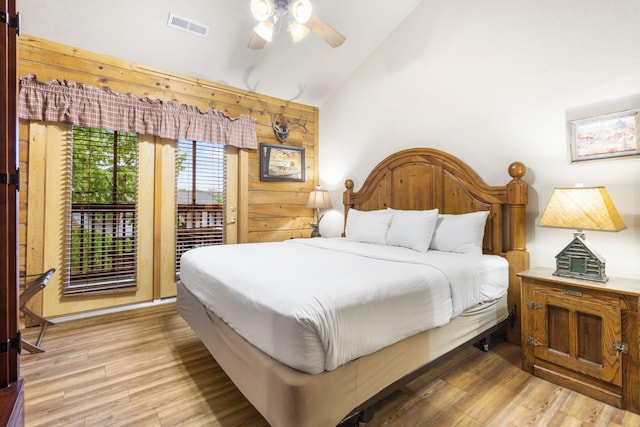 135 Rock Candy Ln, Branson, MO 65616 - bedroom with light wood-style floors, access to exterior, lofted ceiling, and visible vents