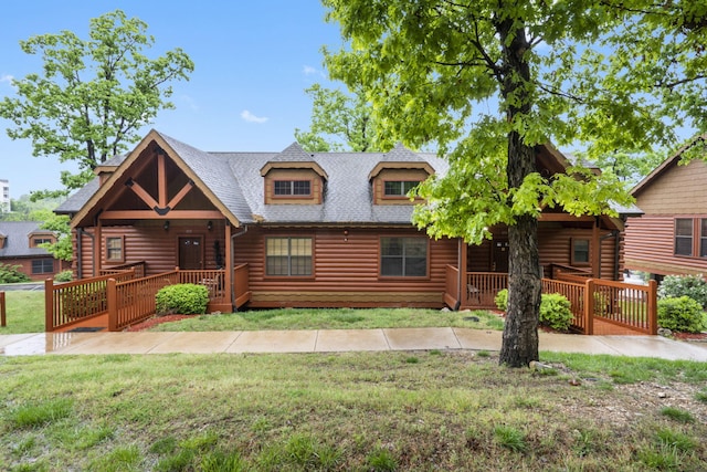 135 Rock Candy Ln, Branson, MO 65616 - log-style house featuring a porch, a front lawn, a shingled roof, and log veneer siding