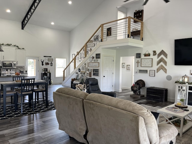 3826 S 77th Rd, Dunnegan, MO 65640 - living room featuring a towering ceiling, baseboards, recessed lighting, stairway, and dark wood finished floors