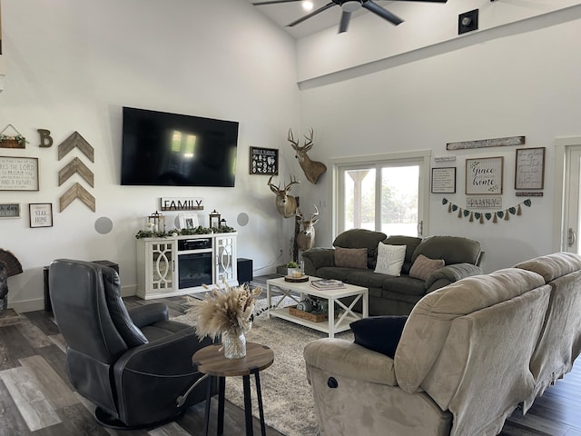 3826 S 77th Rd, Dunnegan, MO 65640 - living room featuring baseboards, a ceiling fan, a towering ceiling, and wood finished floors
