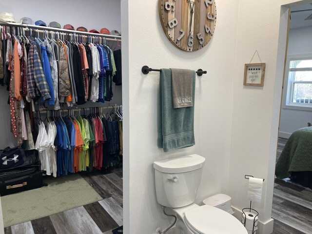 3826 S 77th Rd, Dunnegan, MO 65640 - bathroom with toilet, wood finished floors, and a spacious closet