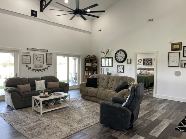 3826 S 77th Rd, Dunnegan, MO 65640 - living area with a towering ceiling, a ceiling fan, visible vents, dark wood-style flooring, and baseboards