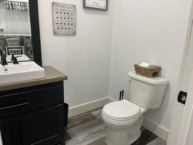 3826 S 77th Rd, Dunnegan, MO 65640 - half bath with vanity, baseboards, a textured wall, toilet, and wood finished floors