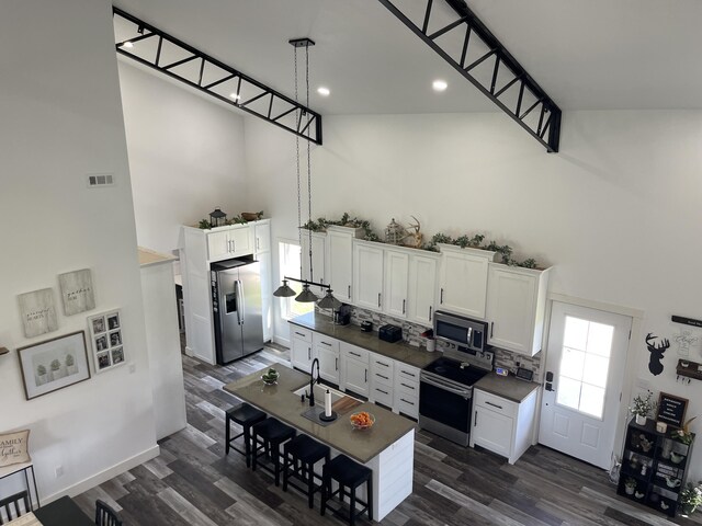 3826 S 77th Rd, Dunnegan, MO 65640 - kitchen with dark wood finished floors, white cabinets, visible vents, dark countertops, and stainless steel appliances