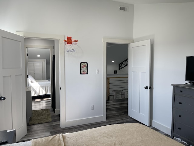 3826 S 77th Rd, Dunnegan, MO 65640 - unfurnished bedroom with visible vents, baseboards, a high ceiling, and wood finished floors