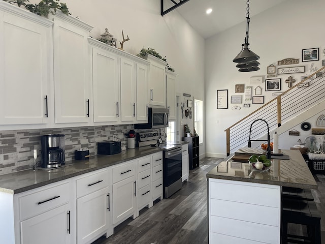3826 S 77th Rd, Dunnegan, MO 65640 - kitchen featuring white cabinets, dark wood-style flooring, backsplash, and appliances with stainless steel finishes