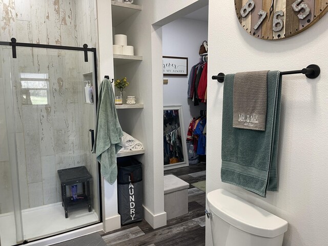 3826 S 77th Rd, Dunnegan, MO 65640 - full bathroom featuring toilet, a stall shower, and wood finished floors