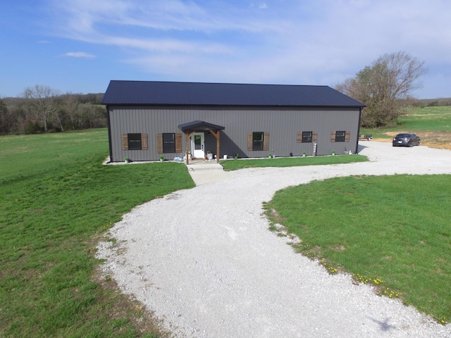 3826 S 77th Rd, Dunnegan, MO 65640 - view of front of property with curved driveway, a front yard, and a pole building