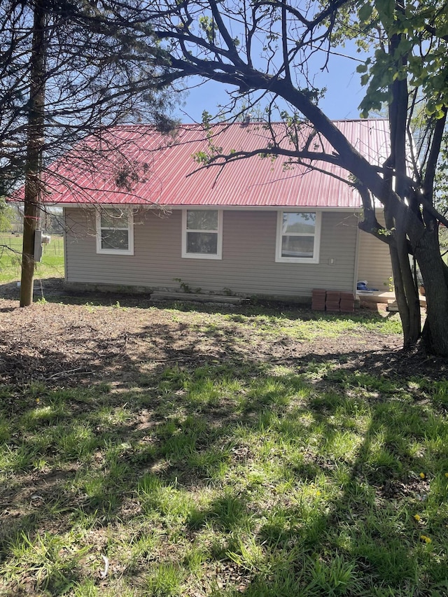 view of side of property with metal roof