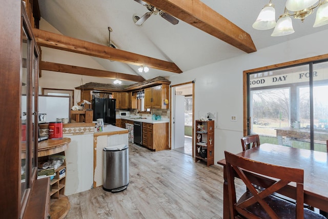 kitchen with lofted ceiling with beams, light countertops, brown cabinetry, black appliances, and ceiling fan with notable chandelier