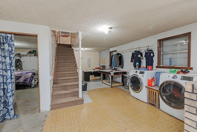 washroom with separate washer and dryer, laundry area, and a textured ceiling