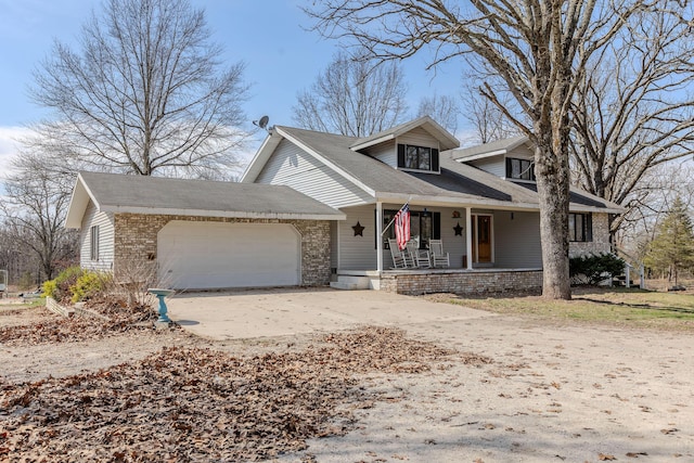 view of front facade featuring an attached garage, covered porch, and concrete driveway