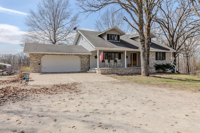view of front of property featuring covered porch, a garage, and concrete driveway
