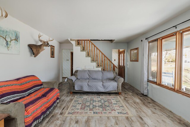 living area featuring wood finished floors and stairs