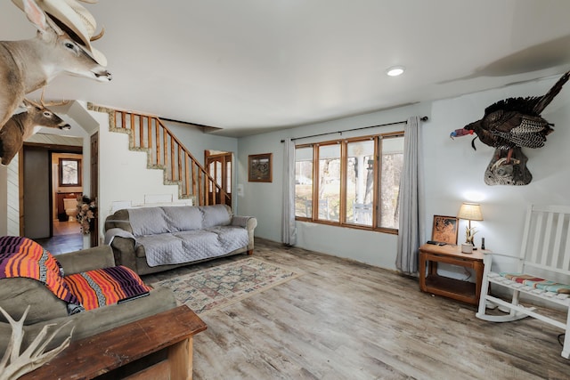 living room with wood finished floors and stairs