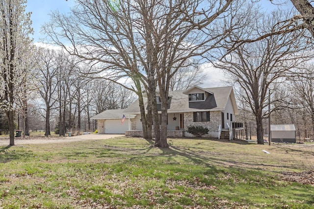 view of front of home featuring a garage, a front yard, and driveway