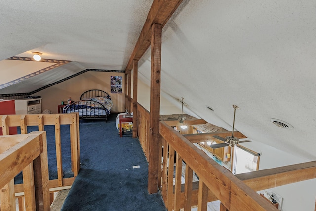 interior space with carpet flooring, visible vents, a textured ceiling, and lofted ceiling with beams