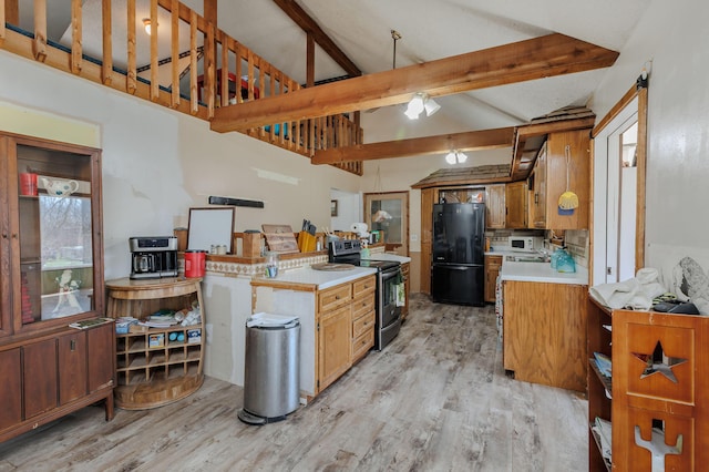 kitchen with light countertops, freestanding refrigerator, electric stove, beam ceiling, and light wood finished floors
