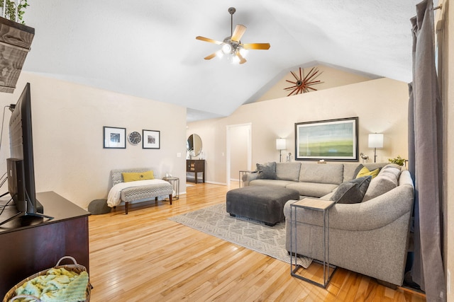 living room featuring arched walkways, ceiling fan, lofted ceiling, and hardwood / wood-style flooring