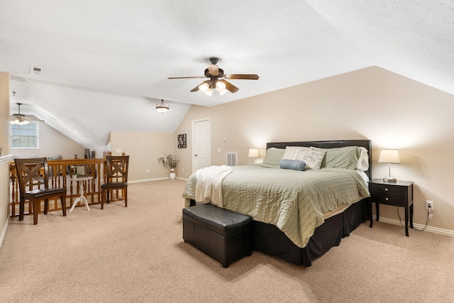 bedroom featuring baseboards, vaulted ceiling, light carpet, a textured ceiling, and visible vents