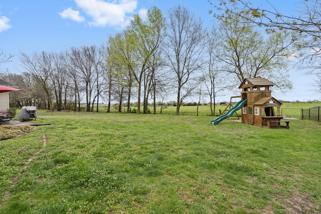 view of yard with fence and a playground