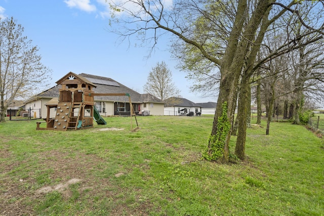 view of yard with fence and a playground