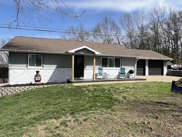 ranch-style house with a front yard, brick siding, and concrete driveway
