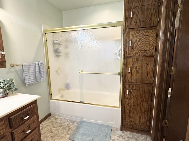 bathroom featuring enclosed tub / shower combo and vanity