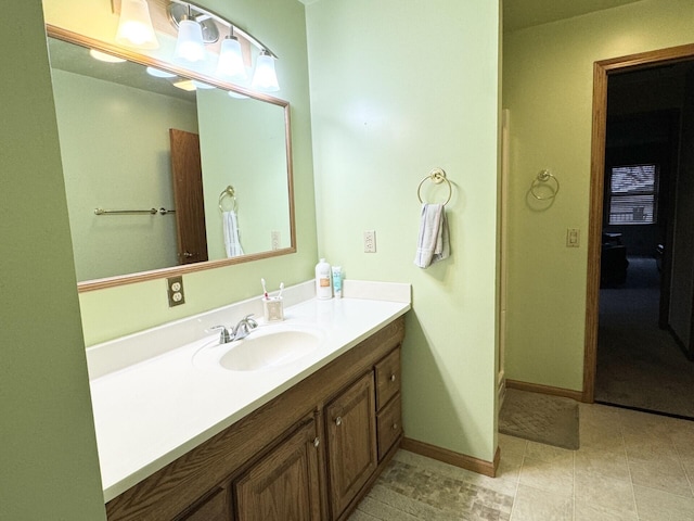 bathroom with baseboards and vanity