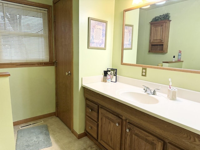 bathroom featuring visible vents, baseboards, tile patterned flooring, and vanity