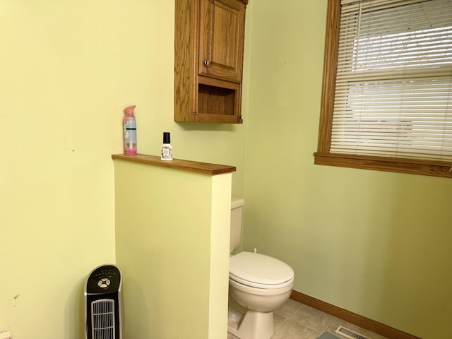 bathroom with toilet, baseboards, tile patterned flooring, and visible vents